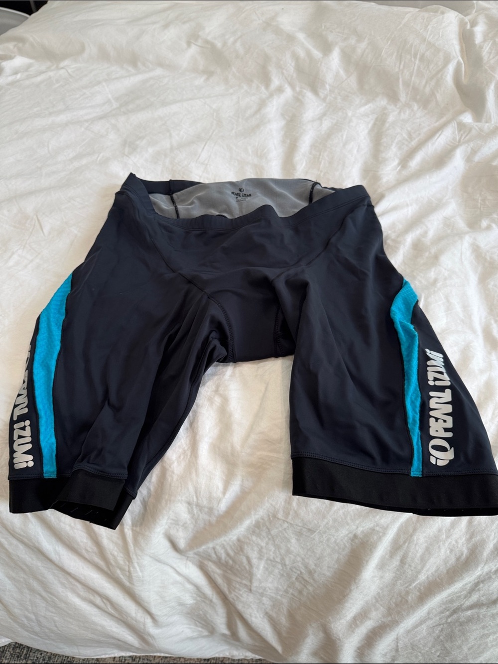 Pearl Izumi Men’s Black Padded Cycling Shorts with Teal Side Panels
